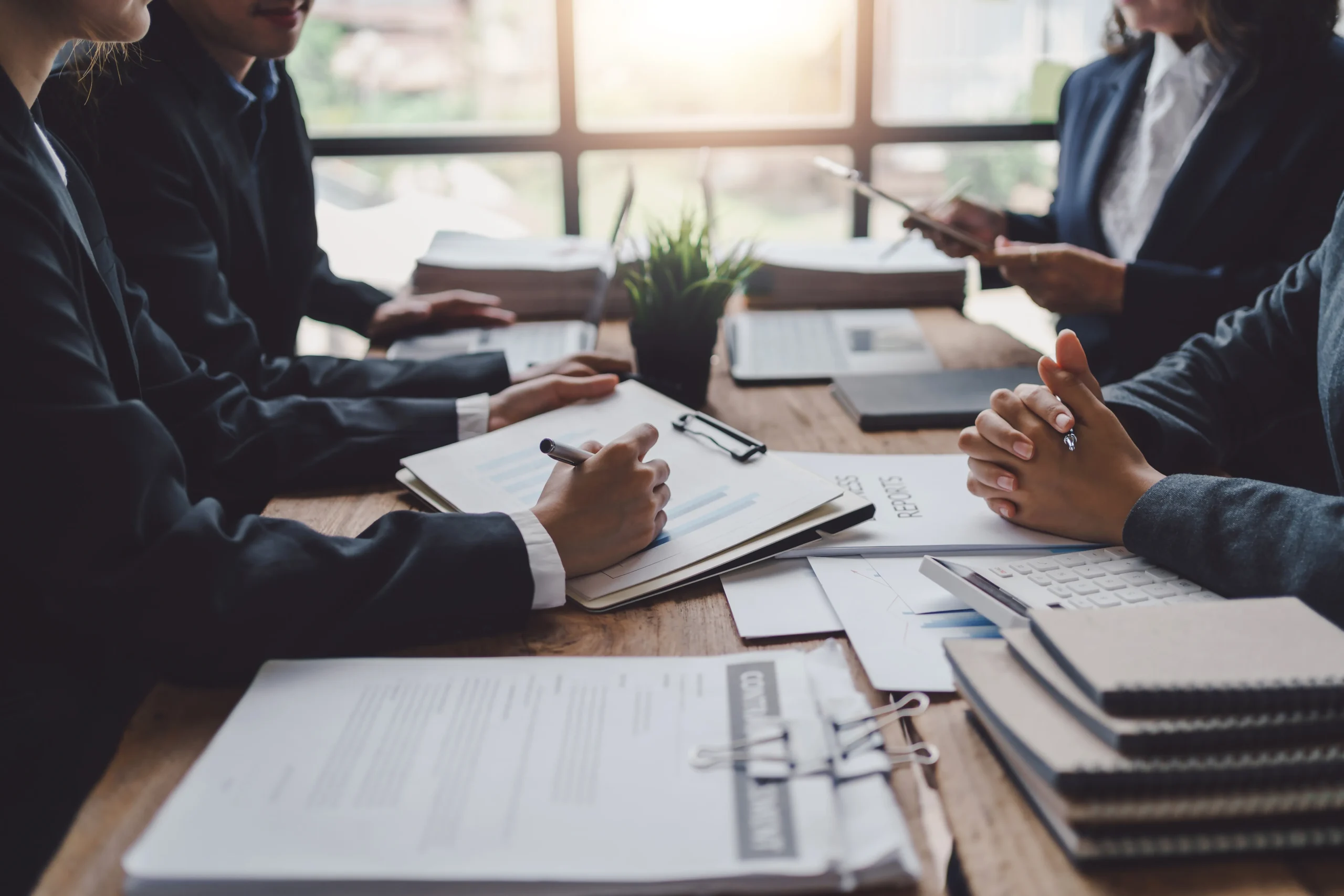 Impetus Group | GST in Singapore: Compliance Priorities for Businesses Business professionals reviewing GST compliance and financial documents in a modern Singapore office.